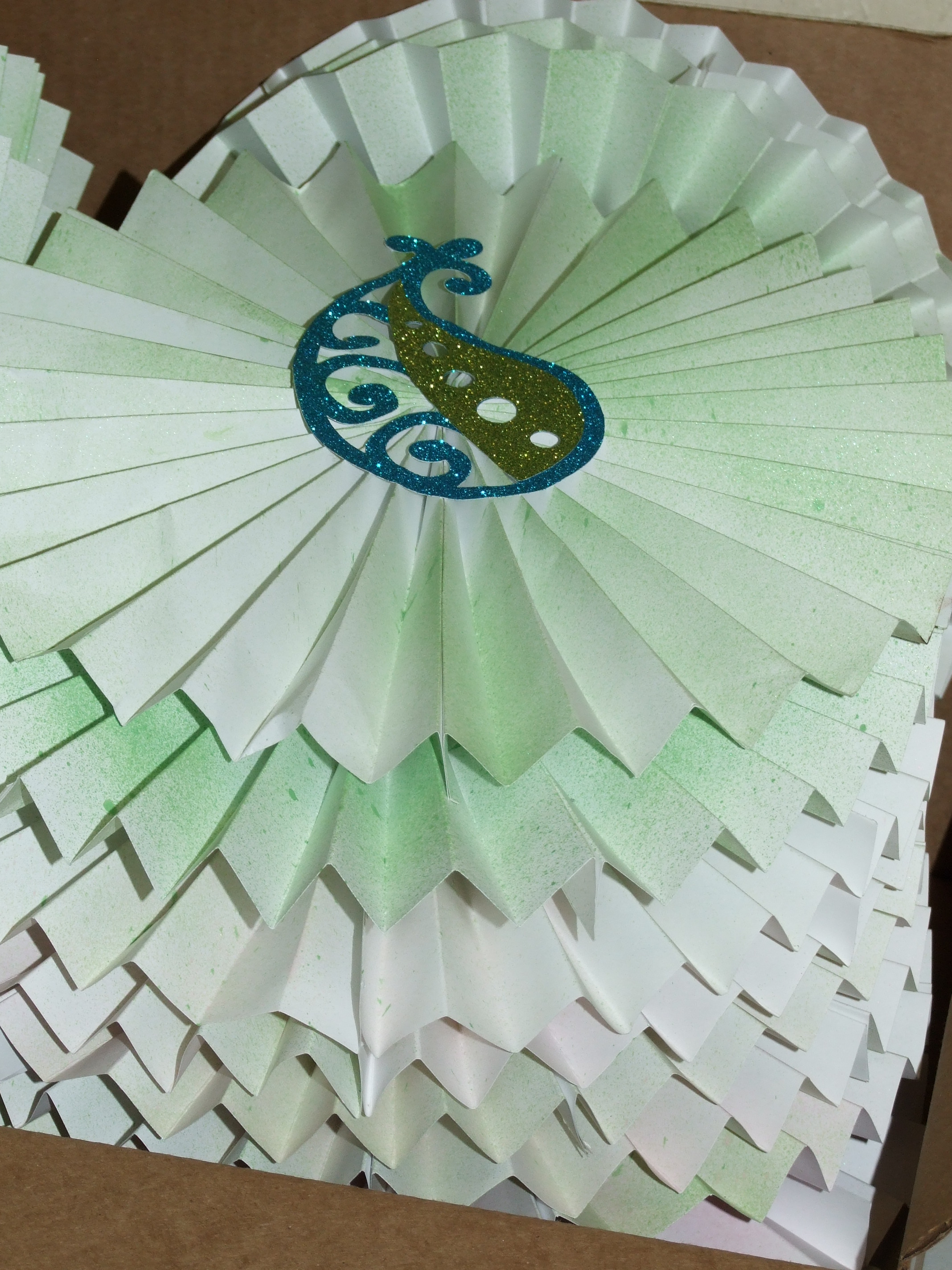 Some paper rosettes I made with help from Mrs. Charlotte and Lillian. These will hang around at our event.